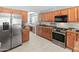 Well-lit kitchen features stainless steel appliances, spacious counters, and light tile flooring at 13630 W Redfield Rd, Surprise, AZ 85379