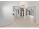 Bright interior showcasing archways, neutral paint, stylish tile flooring, and a modern chandelier at 13630 W Redfield Rd, Surprise, AZ 85379