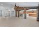 Expansive living area featuring tile flooring, archways, and a stunning stone accent wall at 13630 W Redfield Rd, Surprise, AZ 85379