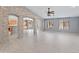 Bright living room features tile flooring, three large windows, and stone pillar accents leading to an open kitchen at 13630 W Redfield Rd, Surprise, AZ 85379