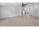 Open-concept living room showcasing stylish tiled flooring and bright, neutral wall color at 13630 W Redfield Rd, Surprise, AZ 85379