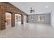 Large living space features attractive tile flooring, archways, stone accents, and neutral wall color at 13630 W Redfield Rd, Surprise, AZ 85379