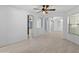 Open-concept living room showing arches, neutral paint, and tiled flooring, offering a spacious atmosphere at 13630 W Redfield Rd, Surprise, AZ 85379
