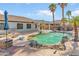 Inviting backyard pool featuring rock accents, a waterfall, and a built-in outdoor kitchen perfect for entertaining at 13630 W Redfield Rd, Surprise, AZ 85379