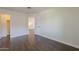 Bright bedroom with wood flooring and an open doorway leading to another room for versatile use at 15828 N 10Th Pl, Phoenix, AZ 85022
