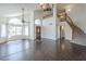 Bright living room boasting hardwood floors, a staircase, and a large arched window at 15828 N 10Th Pl, Phoenix, AZ 85022