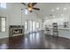 Open-concept living room showcasing a stone fireplace, high ceilings, and a breakfast bar at 15828 N 10Th Pl, Phoenix, AZ 85022