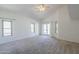 Serene bedroom features vaulted ceiling, large windows, and access to outdoor space at 15828 N 10Th Pl, Phoenix, AZ 85022