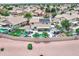Aerial view of a home with a backyard pool, fire pit, covered seating areas, and solar panels at 16197 N 157Th Ave, Surprise, AZ 85374