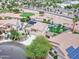 Aerial view of a well-maintained home with a pool, fire pit, mature landscaping and solar panels at 16197 N 157Th Ave, Surprise, AZ 85374