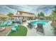 Spacious backyard with a sparkling pool, fire pit area, lounge chairs, and covered seating areas at 16197 N 157Th Ave, Surprise, AZ 85374
