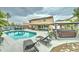 Backyard with a sparkling pool, lounge chairs, a hot tub and two covered patio areas at 16197 N 157Th Ave, Surprise, AZ 85374