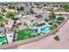 A charming home boasts a backyard oasis with a pristine pool, lush green lawn, and cozy seating, perfect for outdoor relaxation at 16197 N 157Th Ave, Surprise, AZ 85374