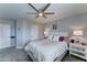 Cozy bedroom featuring plush carpeting, a lighted ceiling fan, and serene, soft blue wall paint at 16197 N 157Th Ave, Surprise, AZ 85374