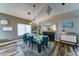 Formal dining room boasts a chandelier, stylish decor, and abundant natural light, perfect for hosting gatherings at 16197 N 157Th Ave, Surprise, AZ 85374