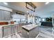 Bright kitchen boasts stainless steel appliances, granite countertops, an island, and custom lighting at 16197 N 157Th Ave, Surprise, AZ 85374