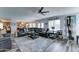 Open-concept living room featuring a large black leather sectional and views into the kitchen and dining area at 16197 N 157Th Ave, Surprise, AZ 85374