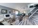 Stylish living room featuring soaring ceilings, modern furniture, and a staircase leading to the second floor, perfect for entertaining at 16197 N 157Th Ave, Surprise, AZ 85374