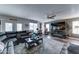 A living room with a large sectional couch, modern decor, backyard access, and a ceiling fan at 16197 N 157Th Ave, Surprise, AZ 85374