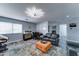 Inviting living room with modern lighting, stylish furniture, and functional workspace with whiteboards at 16197 N 157Th Ave, Surprise, AZ 85374