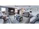 Spacious living room featuring a ceiling fan, a large screen TV, and comfortable furnishings at 16197 N 157Th Ave, Surprise, AZ 85374