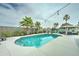 Backyard oasis showcasing a sparkling pool with lush palm trees and a covered gazebo with seating at 16197 N 157Th Ave, Surprise, AZ 85374