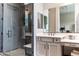 Bright bathroom featuring a glass shower, double vanity, and a large mirror at 1659 N Channing --, Mesa, AZ 85207