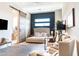 Bright bedroom with a modern design, a king size bed, and a sliding barn door to the bathroom at 1659 N Channing --, Mesa, AZ 85207