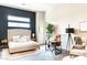 Bright bedroom with a modern design, a king size bed, and a dedicated work space with a desk at 1659 N Channing --, Mesa, AZ 85207