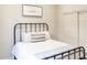 This neutral bedroom has a metal bed frame, comfortable bedding, and a closet at 1659 N Channing --, Mesa, AZ 85207