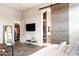 Spacious primary bedroom featuring a sliding barn door to the bath, a closet and television at 1659 N Channing --, Mesa, AZ 85207