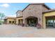 Stone clubhouse with shaded outdoor seating and beautifully potted flowers create a welcoming gathering space at 1659 N Channing --, Mesa, AZ 85207