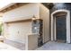 A beautifully detailed front door is showcased, highlighted by warm lantern lighting and stone accents at 1659 N Channing --, Mesa, AZ 85207