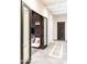 View of a hallway with a decorative rug, stylish mirrors, bench, doorway, and a seating area beyond at 1659 N Channing --, Mesa, AZ 85207