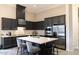 Modern kitchen with dark cabinetry, stainless steel appliances, and a center island with seating at 1659 N Channing --, Mesa, AZ 85207