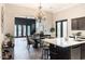 Open-concept kitchen connected to a dining area, featuring an island with bar stools at 1659 N Channing --, Mesa, AZ 85207