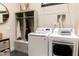 Functional laundry room features modern appliances, storage, and hooks for organization at 1659 N Channing --, Mesa, AZ 85207