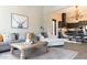 Cozy living room with neutral tones, wood accents, and an open flow to kitchen creates an inviting space at 1659 N Channing --, Mesa, AZ 85207