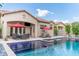 A stunning backyard pool and patio, complete with lounge chairs and an outdoor living space with a TV at 1659 N Channing --, Mesa, AZ 85207