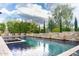 Beautiful pool area surrounded by lush greenery and a spa with seating area inside at 1659 N Channing --, Mesa, AZ 85207