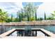 A luxurious backyard pool and spa are framed by a decorative stone wall with small water features at 1659 N Channing --, Mesa, AZ 85207