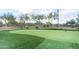 Putting green featuring artificial turf, multiple holes with flags, and views of desert landscaping at 1659 N Channing --, Mesa, AZ 85207