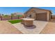 Beautiful backyard featuring artificial turf, a built-in grill and desert landscaping at 18434 E El Buho Pequeno Rd, Gold Canyon, AZ 85118