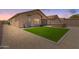 Beautiful backyard featuring artificial turf, a built-in grill and desert landscaping at 18434 E El Buho Pequeno Rd, Gold Canyon, AZ 85118