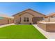 Backyard featuring artificial turf, a built-in grill and desert landscaping at 18434 E El Buho Pequeno Rd, Gold Canyon, AZ 85118