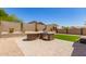 Backyard featuring artificial turf, a built-in grill and desert landscaping at 18434 E El Buho Pequeno Rd, Gold Canyon, AZ 85118