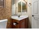 Bathroom featuring a vanity with dark wood cabinets, sink, decorative wall, and toilet at 18434 E El Buho Pequeno Rd, Gold Canyon, AZ 85118