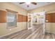 Bright bedroom featuring wood-look flooring, neutral walls, and large windows that let in ample natural light at 18434 E El Buho Pequeno Rd, Gold Canyon, AZ 85118