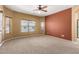 Spacious bedroom with plush carpeting, large windows, and calming wall colors, creating a cozy and relaxing retreat at 18434 E El Buho Pequeno Rd, Gold Canyon, AZ 85118