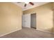 Bedroom with ceiling fan, carpeted floor, closet, and neutral wall color at 18434 E El Buho Pequeno Rd, Gold Canyon, AZ 85118